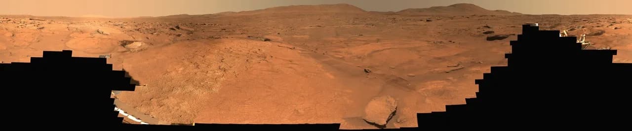 Perseverance rover panorama of the reddish Margin Unit landscape at the inner rim of Mars’ Jezero Crater, with rover hardware in the foreground.