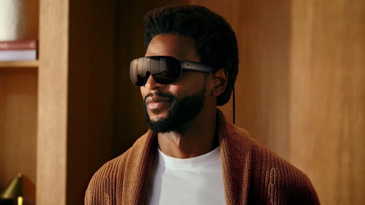 Person wearing Meta’s lightweight VR glasses against a muted background.