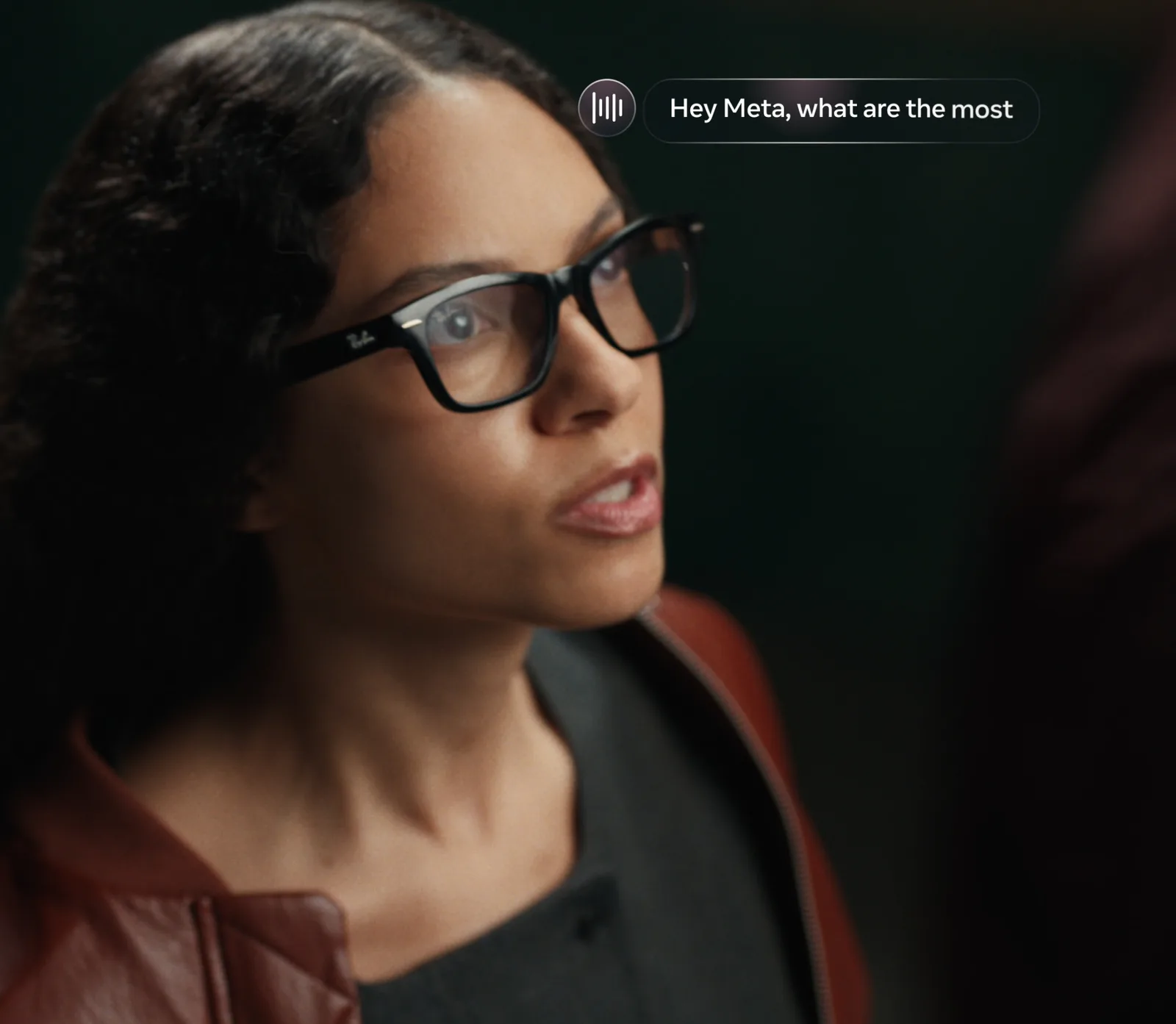 A woman wearing Ray-Ban Meta Audio glasses with a voice-command overlay.